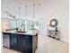 Open-concept kitchen featuring a central island with granite countertop, dark cabinets, and stainless steel appliances at 14014 Millington St, Orlando, FL 32832