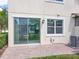 The patio features a sliding glass door, brick pavers, and well-maintained landscaping at 14014 Millington St, Orlando, FL 32832