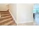 Carpeted staircase leading to the upper level, showcasing neutral wall colors at 14014 Millington St, Orlando, FL 32832