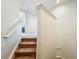 Staircase features carpeted stairs and white banister leading to the upper level at 14014 Millington St, Orlando, FL 32832