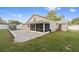 Home's backyard showing a screened-in patio and a block-paved patio area at 145 Burns Ave, Longwood, FL 32750