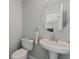 Powder room featuring toilet, vanity, and decorative mirror at 145 Burns Ave, Longwood, FL 32750
