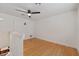 Neutral bedroom featuring a ceiling fan, hardwood floors, and bright white walls at 145 Burns Ave, Longwood, FL 32750