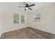Bedroom with hardwood floors and two windows with blinds for natural light at 145 Burns Ave, Longwood, FL 32750