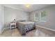 This bedroom includes tiled floors, neutral paint, and two windows for natural light at 145 Burns Ave, Longwood, FL 32750