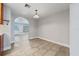 Bright dining room featuring neutral paint, tile floors, and arched doorway at 145 Burns Ave, Longwood, FL 32750