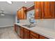 Kitchen featuring wood cabinets, stainless steel appliances, and tile floors at 145 Burns Ave, Longwood, FL 32750