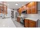 Galley kitchen featuring stainless steel appliances and wood cabinetry at 145 Burns Ave, Longwood, FL 32750