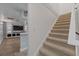 A carpeted staircase leading to the lower level, including the bar and living room area at 145 Burns Ave, Longwood, FL 32750