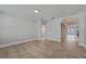 Bright living room featuring neutral paint, tile floors, and arched doorway at 145 Burns Ave, Longwood, FL 32750