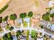 Full overhead shot of a suburban neighborhood featuring tidy lawns and tree-lined streets at 14723 Peppermill Trl, Clermont, FL 34711