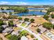 Beautiful aerial view of the community featuring a picturesque lake and gorgeous surrounding landscape at 14723 Peppermill Trl, Clermont, FL 34711