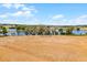 Aerial view of a landscape featuring a lake, open land, and sparse trees, suggesting a rural or developing area at 14723 Peppermill Trl, Clermont, FL 34711