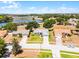 Breathtaking aerial view showcases the homes idyllic setting with stunning lake views and lush greenery at 14723 Peppermill Trl, Clermont, FL 34711