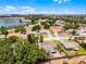 Stunning aerial shot of the community, featuring a picturesque lake and lush landscaping all around at 14723 Peppermill Trl, Clermont, FL 34711