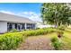 Backyard showcasing lush landscaping, a mulch path, and a screened-in patio, perfect for outdoor relaxation at 14723 Peppermill Trl, Clermont, FL 34711