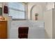 Bright bathroom features a soaking tub beneath a window with decorative tile and alcove at 14723 Peppermill Trl, Clermont, FL 34711
