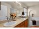 A bright bathroom featuring dual sinks, a soaking tub, and modern fixtures at 14723 Peppermill Trl, Clermont, FL 34711