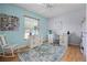 Charming bedroom with a ceiling fan, a large window, and a white work station with storage at 14723 Peppermill Trl, Clermont, FL 34711