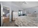 Light-filled bedroom showing serene decor and an open doorway to an adjacent room at 14723 Peppermill Trl, Clermont, FL 34711