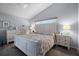 A bright bedroom with a white bed set, ample lighting and calm atmosphere at 14723 Peppermill Trl, Clermont, FL 34711