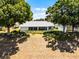 Charming home exterior with manicured lawn, mature trees, and a screened-in lanai for relaxing at 14723 Peppermill Trl, Clermont, FL 34711