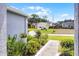 Inviting front entrance with a decorative glass door and manicured landscaping at 14723 Peppermill Trl, Clermont, FL 34711