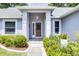 Inviting front entrance with a decorative glass door and manicured landscaping at 14723 Peppermill Trl, Clermont, FL 34711