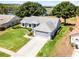 Charming single-story home with a well-maintained lawn and an attached two-car garage near a lake at 14723 Peppermill Trl, Clermont, FL 34711