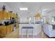 Open kitchen with stainless steel appliances, breakfast bar, and adjacent living area at 14723 Peppermill Trl, Clermont, FL 34711