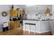 Eat-in kitchen boasts stainless steel appliances, breakfast bar, and pendant lighting at 14723 Peppermill Trl, Clermont, FL 34711