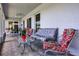 Covered lanai with comfortable seating offers a serene outdoor retreat to enjoy the garden view at 14723 Peppermill Trl, Clermont, FL 34711