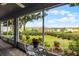 Screened lanai with table and chairs offering scenic views of the garden and surrounding landscape at 14723 Peppermill Trl, Clermont, FL 34711