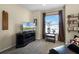 A cozy living room with plush carpet, a modern entertainment center, and bright natural light at 14723 Peppermill Trl, Clermont, FL 34711
