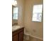 A clean bathroom featuring granite countertop, neutral walls, and a window at 14867 Driftwater Dr, Winter Garden, FL 34787