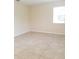 A serene bedroom featuring neutral walls, tiled floors, and a bright window at 14867 Driftwater Dr, Winter Garden, FL 34787