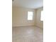 A bright bedroom with neutral walls, tile floors, and dual windows for natural light at 14867 Driftwater Dr, Winter Garden, FL 34787