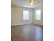 Bright bedroom featuring two windows and modern floors at 14867 Driftwater Dr, Winter Garden, FL 34787