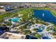 Aerial view of the community featuring a lake, swimming pools, and recreational areas at 1569 Carey Palm Cir, Kissimmee, FL 34747