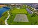 Aerial shot of community amenities, with a basketball court, soccer field, and lakeside walking path at 1569 Carey Palm Cir, Kissimmee, FL 34747