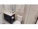 Bright bathroom featuring a vanity with dark cabinets, a toilet, and a walk-in shower at 1569 Carey Palm Cir, Kissimmee, FL 34747