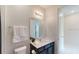 This well-lit bathroom features a toilet, vanity, and a decorative plant at 1569 Carey Palm Cir, Kissimmee, FL 34747