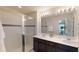 The bathroom features a glass enclosed shower, dual sinks and a large mirror at 1569 Carey Palm Cir, Kissimmee, FL 34747