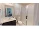 Bright bathroom featuring a vanity with dark cabinets, a toilet, and a walk-in shower at 1569 Carey Palm Cir, Kissimmee, FL 34747