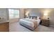 The bedroom has a king bed with plush bedding and neutral colors, creating a serene and inviting atmosphere at 1569 Carey Palm Cir, Kissimmee, FL 34747