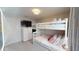 White bunk bed with pink pillows next to a four-drawer dresser in this well-lit bedroom at 1569 Carey Palm Cir, Kissimmee, FL 34747