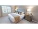 The bedroom has a king bed with plush bedding and neutral colors, creating a serene and inviting atmosphere at 1569 Carey Palm Cir, Kissimmee, FL 34747