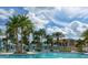 Community pool with luxurious cabanas and ample seating for enjoying the Florida sunshine at 1569 Carey Palm Cir, Kissimmee, FL 34747