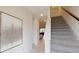 Entryway with staircase and a large decorative painting on the wall at 1569 Carey Palm Cir, Kissimmee, FL 34747