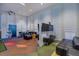 Spacious game room with TVs, seating, and game tables for Gathering entertainment at 1569 Carey Palm Cir, Kissimmee, FL 34747